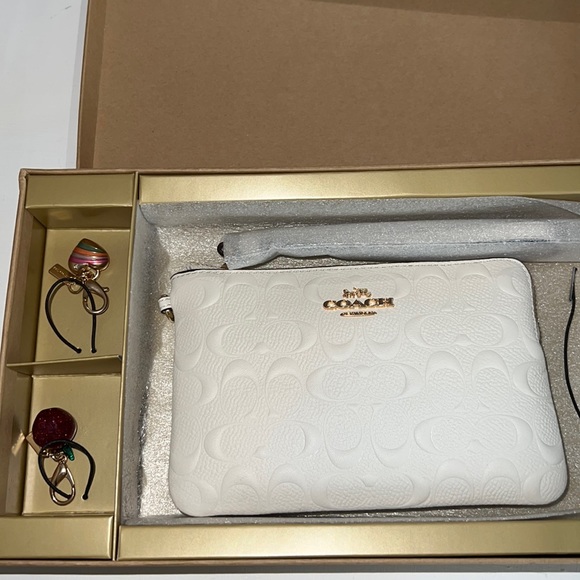 Coach Handbags - Brand new in box coach wristlet with two charms